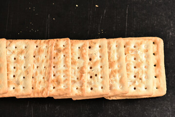cracker, flour biscuit healthy food snack isolated on black background with space for text