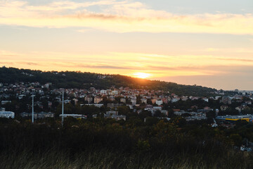 Belgrade at sunset, Serbia country. A residential area in suburbs of capital in evening in rays of setting sun. High-rise buildings and private houses.