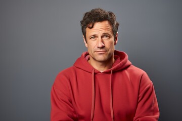 Obraz premium Portrait of a merry man in his 40s dressed in a comfy fleece pullover isolated in blank studio backdrop