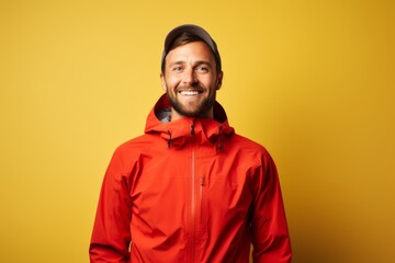 Obraz premium Portrait of a happy man in his 30s wearing a windproof softshell in light wood minimalistic setup