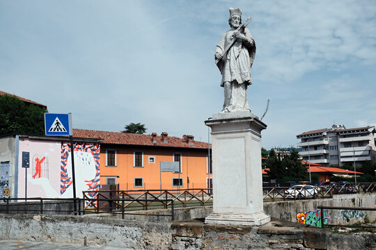Bergamo, Italy - September 4, 2024. Street view in Upper Town, Citta Alta in Bergamo city, Italy. the statue of the Saint Giovanni on the Morla bridge in Borgo Palazzo. 