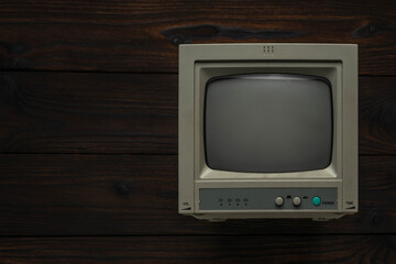 Vintage Cathode Ray Tube Television on Dark Wooden Background