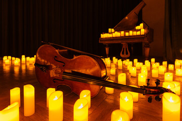closeup of violin with lots of candles
