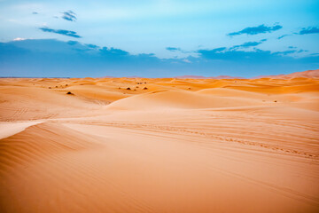 Merzouga, Morocco - Sunrise in desert tour on top of Erg Chebbi dunes and path for camping in the Sahara. Overnight destination in Berber desert camp