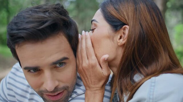 Happy couple gossiping nature spending weekend together closeup. Girl whispering