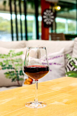 A glass of red wine on restaurant table. 
