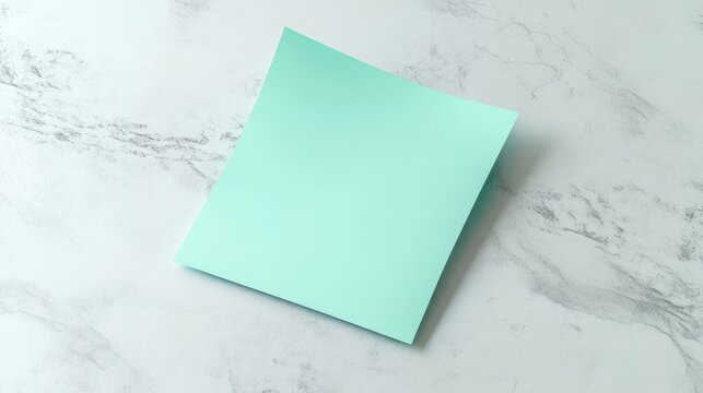 A single mint-green sticky note placed on a light textured background, ideal for reminders and notes.