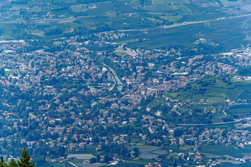 Aerial view of Italian City of Meran with Etsch Valley and Etsch River seen from mountain resort...
