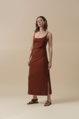 Serie of studio photos of young female model in brown cotton camisole dress. Classic and simple summer fashion.	