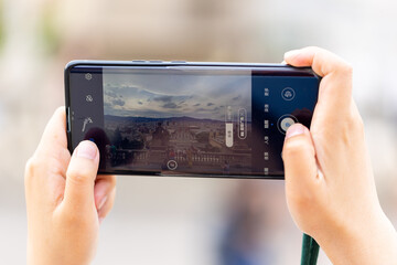 Unrecognizable person taking a picture with a smartphone in Montjuic, Barcelona (Spain
