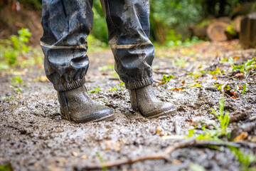 Child in welly boots, jump, jumping in mud.