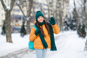 Photo of cute funny schoolgirl wear windbreaker jacket walking college waving arm urban city street © deagreez