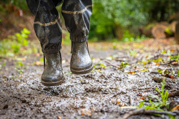 Child in welly boots, jump, jumping in mud.