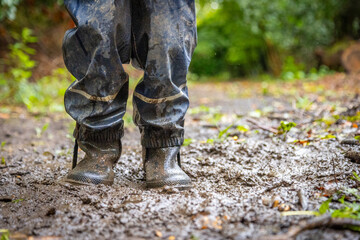 Child in welly boots, jump, jumping in mud.