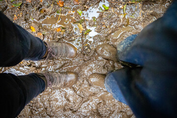 Child in welly boots, jump, jumping in mud.
