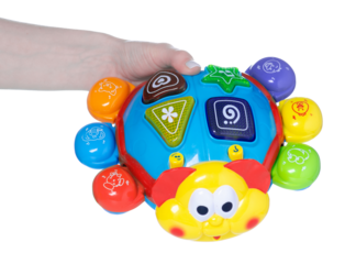 Musical beetle toy in hand isolation