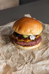 Veggie burger served with flowering herbs