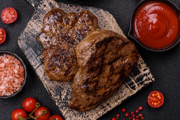 Juicy beef steak grilled with salt, spices and herbs
