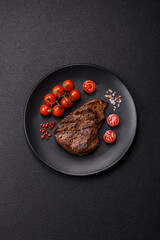 Juicy beef steak grilled with salt, spices and herbs