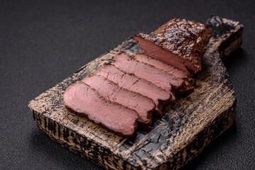 Juicy beef steak grilled with salt, spices and herbs