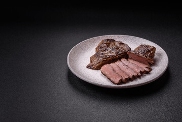 Juicy beef steak grilled with salt, spices and herbs