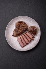 Juicy beef steak grilled with salt, spices and herbs