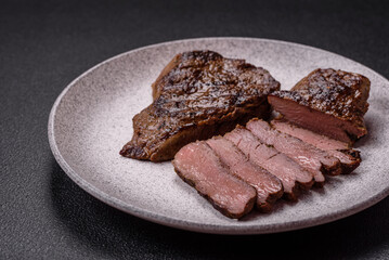 Juicy beef steak grilled with salt, spices and herbs