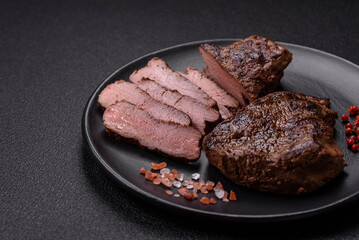 Juicy beef steak grilled with salt, spices and herbs