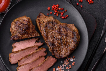 Juicy beef steak grilled with salt, spices and herbs