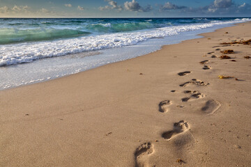 Early walK on a sandy beach finding peace where the ocean meets the sky.  Delray Beach Florida