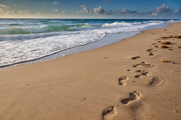 Early walK on a sandy beach finding peace where the ocean meets the sky.  Delray Beach Florida