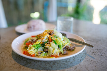 Stir-fried rice noodle with pork and vegetable on plate. Thai food.