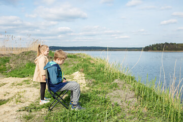 Children Enjoying Nature by Riverbank.