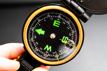 Vintage Compass Displayed in Hand, Navigating with Precision for Outdoor Adventures and Hiking Enthusiasts Seeking Direction and Exploration in Nature