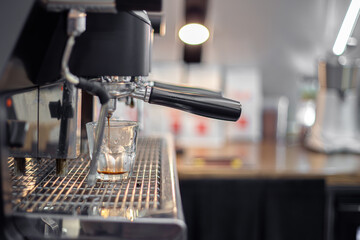 Making coffee by a barista in a coffee machine. The coffee machine makes coffee.