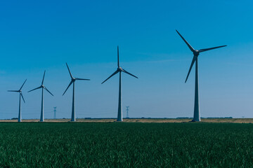 Metal modern windmills spinning with clean wind power generate electricity on innovative farm...