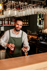 Skilled bartender prepares a cocktail at a stylish bar during a vibrant evening in a bustling city