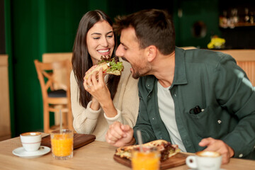 Enjoying a delightful brunch together at a cozy cafe on a sunny afternoon in the heart of the city