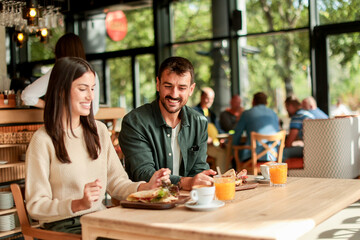 Enjoying a delightful brunch together at a cozy cafe on a sunny afternoon in the heart of the city