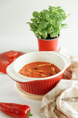 Asian fried eggplant with in sweet and sour spicy sauce from bell pepper, ginger and garlic on white table