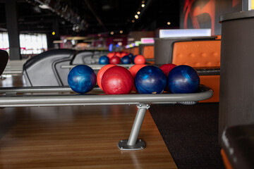 Colorful Bowling Balls on Rack in Modern Bowling Alley