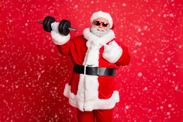 Portrait of cheerful cheery confident funky fat overweight plump gray-haired bearded man demonstrating biceps triceps athlete body building isolated over bright vivid shine red background