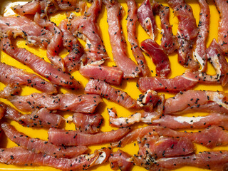 Closeup making sun-dried pork. It's drying in the sun.Food preservation by sun drying pork