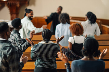 Group of people raising their hands while praying inside the church