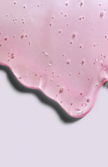 Cream gel pink transparent cosmetic sample texture with bubbles isolated on light gray background