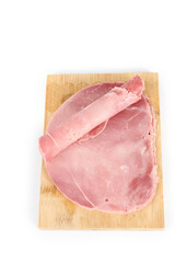slice of ham on a chopping board isolated on white 