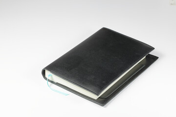 luxury Black Leather Agenda Diary Notebook, or appointment book with bookmark stripe isolated on white background.  Stationery item.