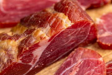 a piece of cured pork ham with thin layers of lard on the table