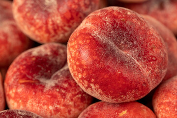 a pile of ripe washed peaches on the table