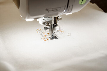 Machine for embroidering colored patterns on fabric.